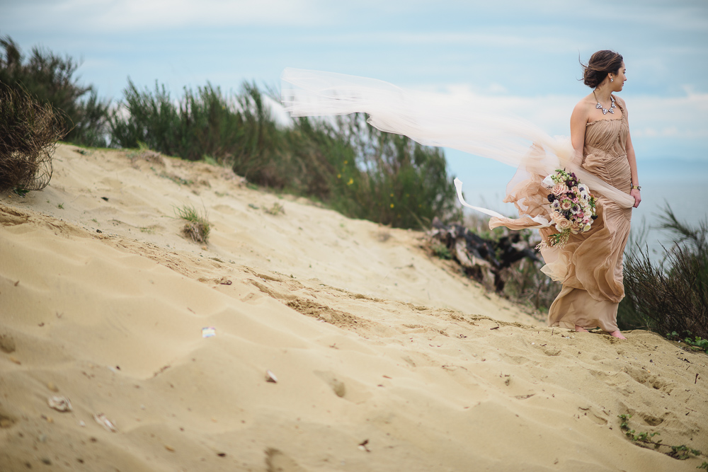 Bride in Wind on CliffColours of the Wind Erin Wallis Photography West Coast Weddings Magazine