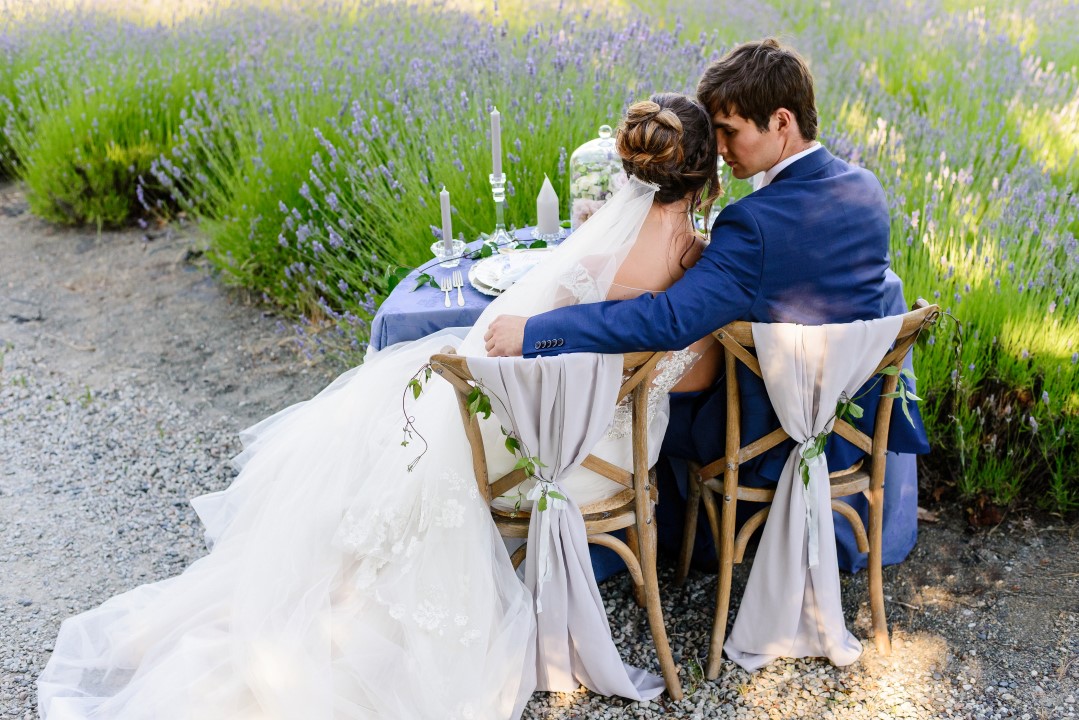 Couple hugging at sweetheart table Kristen Borelli Photography