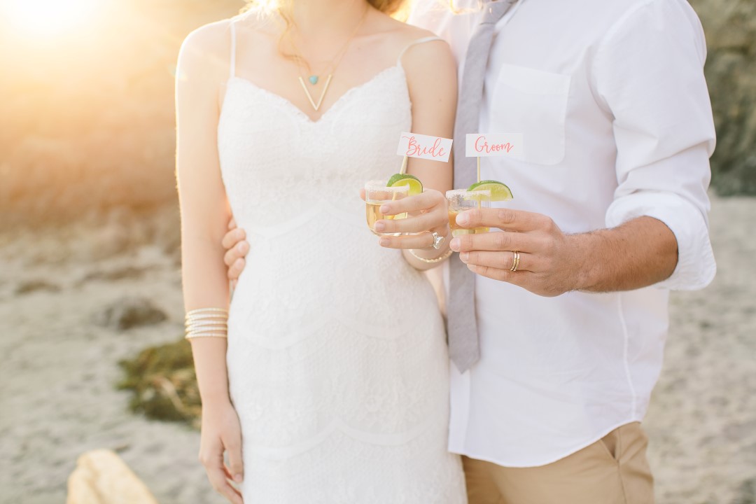 Newlyweds drinking tequila shots on the beach Vancouver Island Wedding Magazine