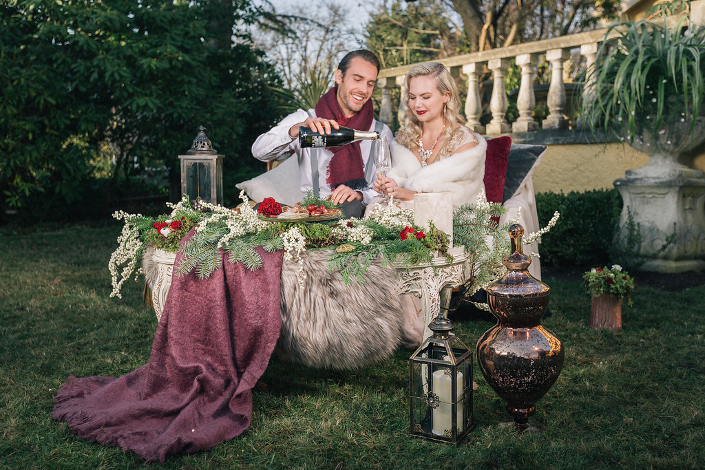 Couple drining wine outside styled proposal Vancouver Island Villa Marco Polo Inn