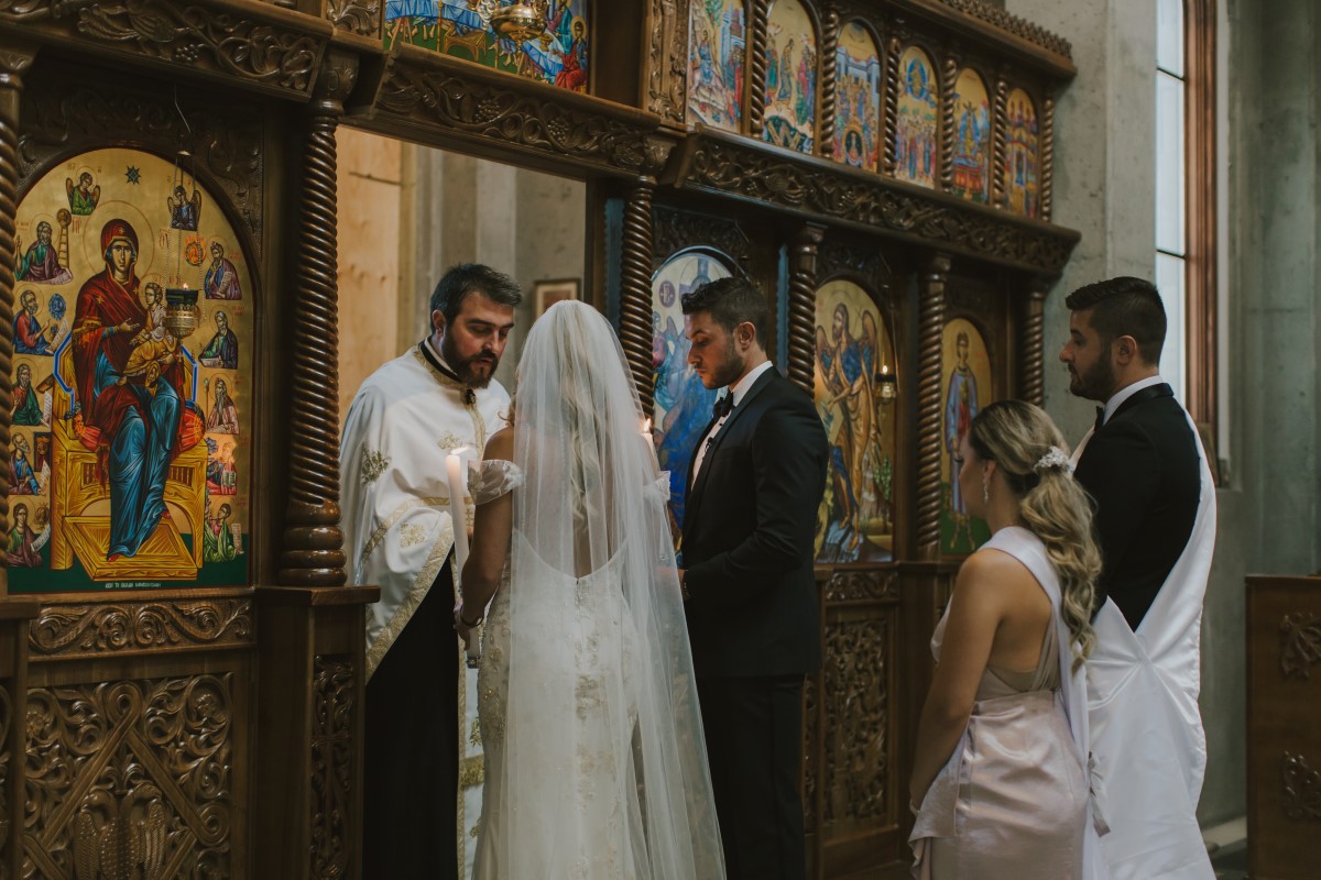 Bride and Groom Blessed by Greek Orthodox Priest Kayseeb abd Stevan Silk Sophistication Ophelia Photography Vancouver West Coast Weddings Magazine