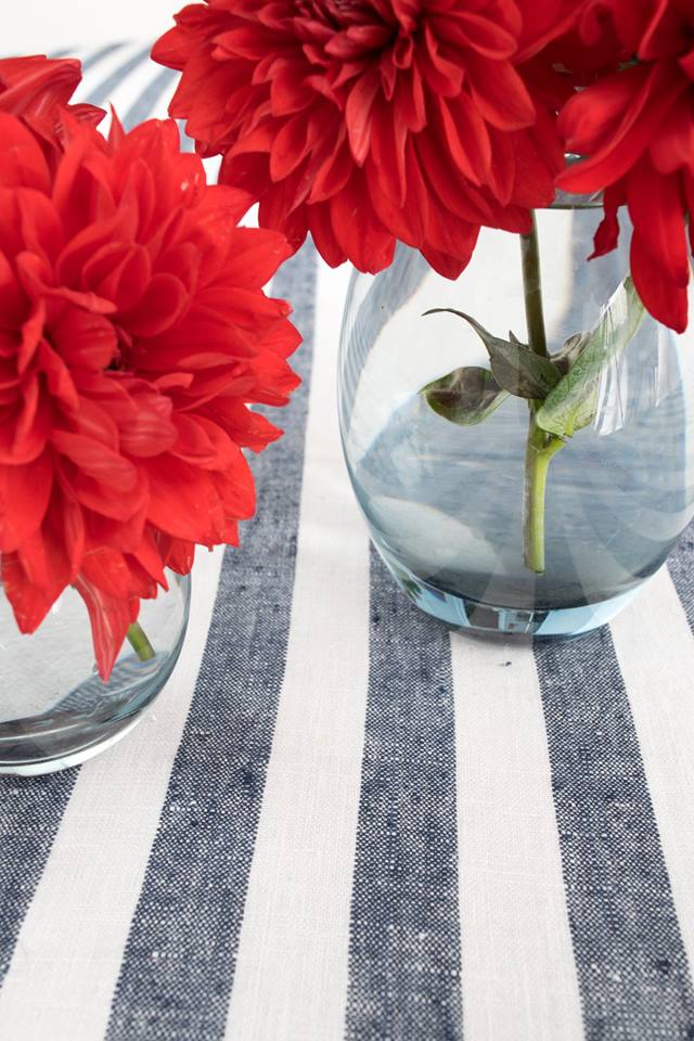 Grey stripe with red flowers wedding table by faire la fete linens vancouver wedding magazine