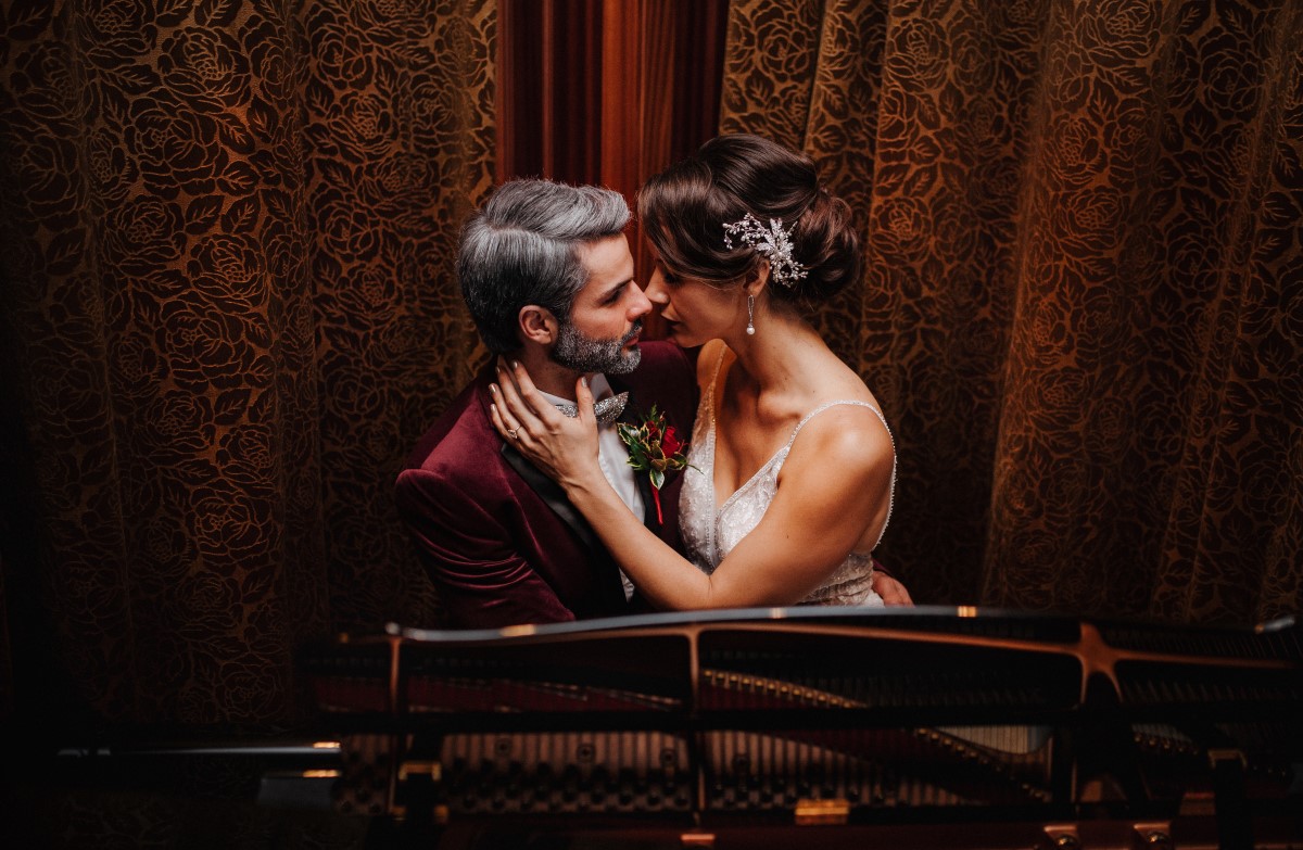 A Glamorous Holiday Wedding Newlyweds in front of fire place at Oak Bay Beach Hotel Tasha Cline Photography