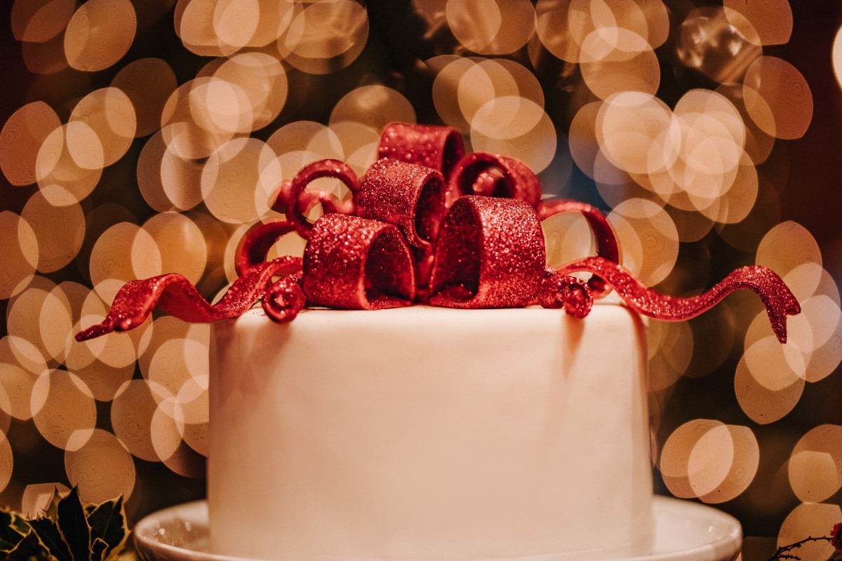 A Glamorous Holiday Wedding Cake with Red Bow Cake Topper by Cake by Taryn Vancouver Island