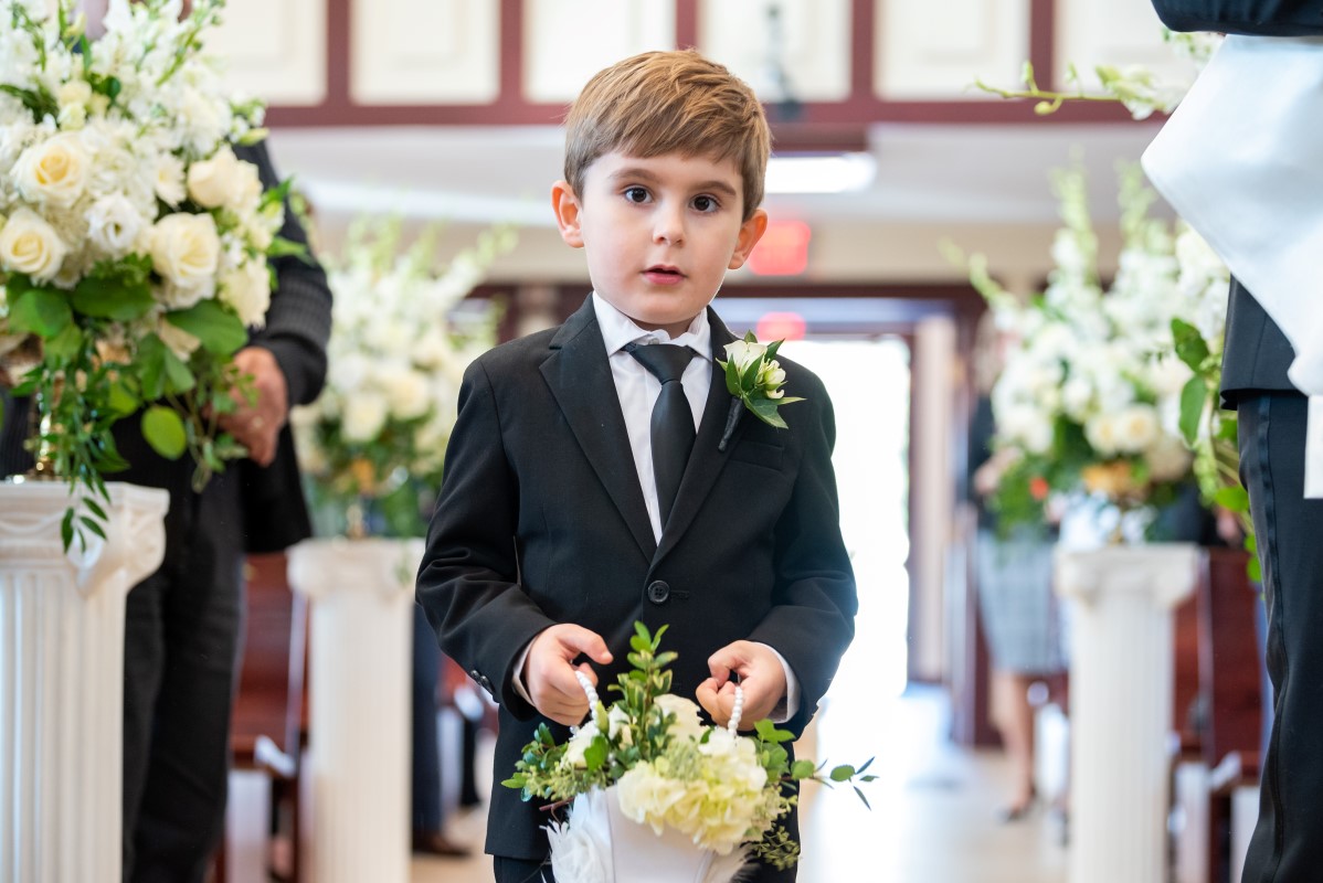 Ringbearer walks up the aisle in Vancouver wedding