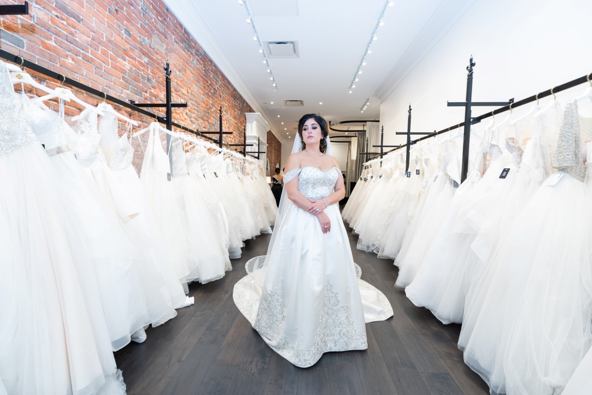 Bride shows off custom gown and veil by Victor Harper of Bridal Gallery Vancouver