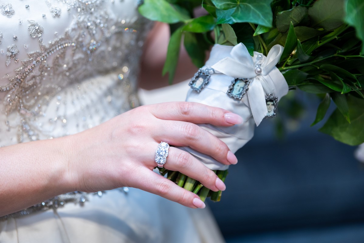 Bridal bouquet with charm photos of relatives not present at the wedding