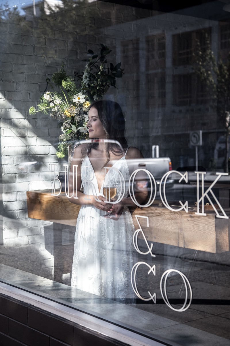 Chic wedding gown in reflection of Burdock & Co in Vancouver Wedding Magazine