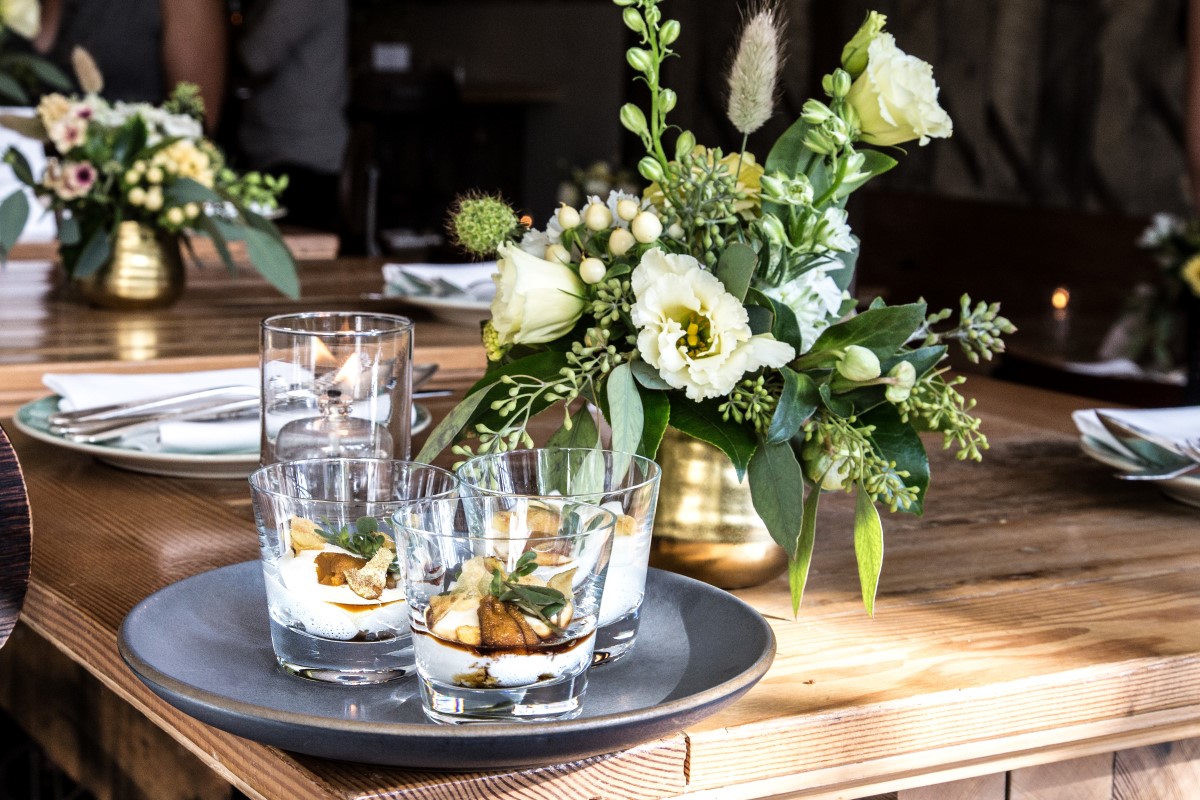 Chic drinks and white floral arrangement on wedding reception table