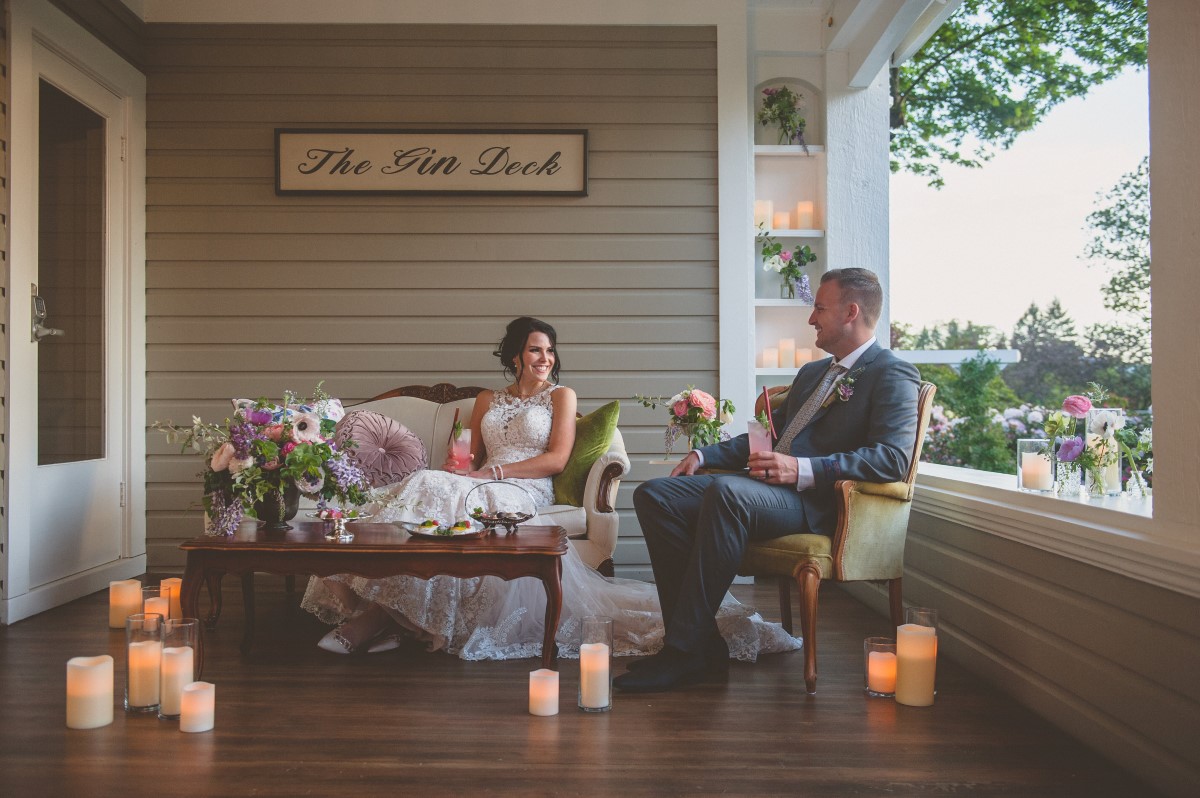 Newlyweds enjoy drink by candlelight on Gin Deck Vancouver Island