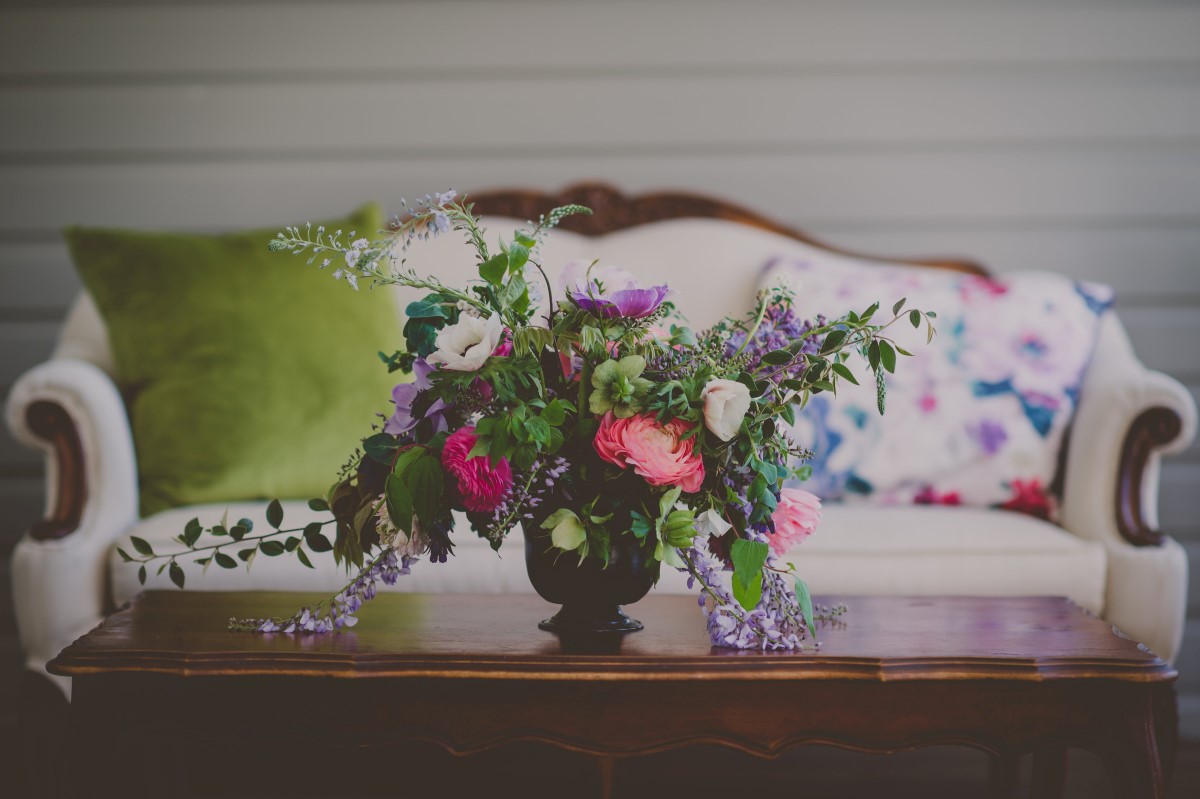 Floral Arrangement on Deck at Wedding with Vintage Couch at Maple Bay Manor