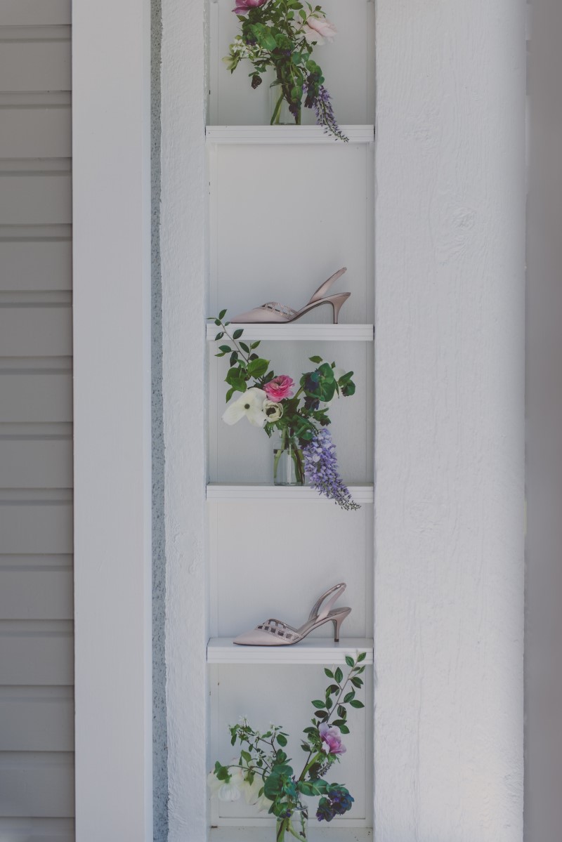 Flowers and brides shoes on deck shelves at wedding venue Vancouver Island Magazine