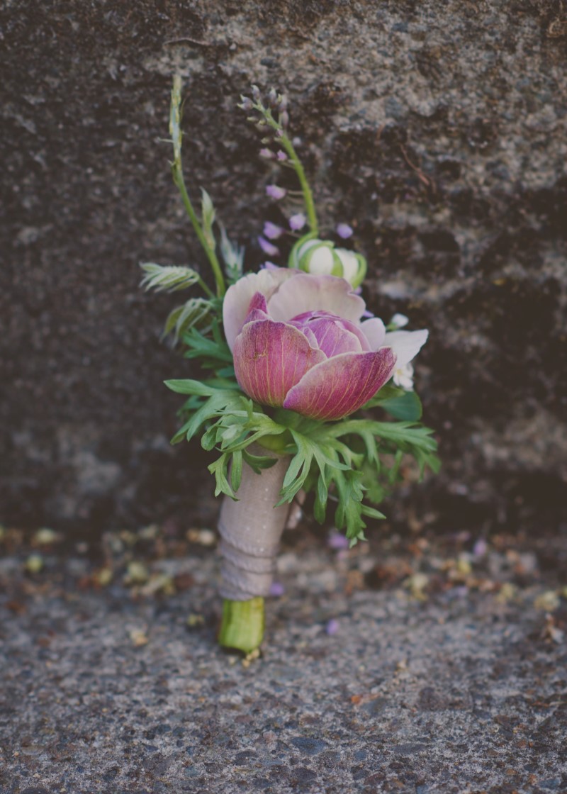 Pink grooms boutonniere with fern and wrapped in rope