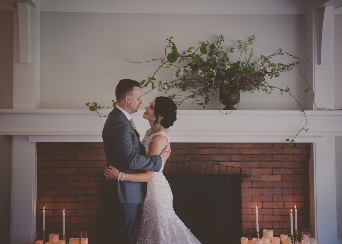 Local Love newlyweds in front of fireplace West Coast Weddings