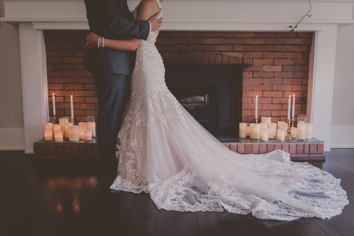 Newlyweds in front of fireplace at Maple Bay Manor Vancouver Island wedding