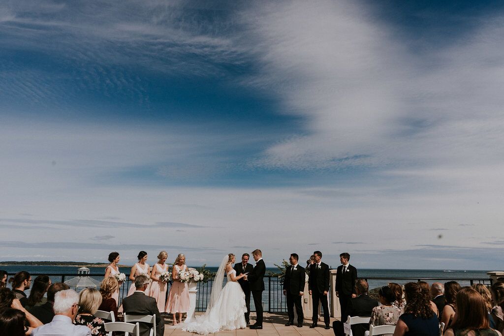 Romantic Wedding Ceremony with Blue Skies behind West Coast Weddings Magazine