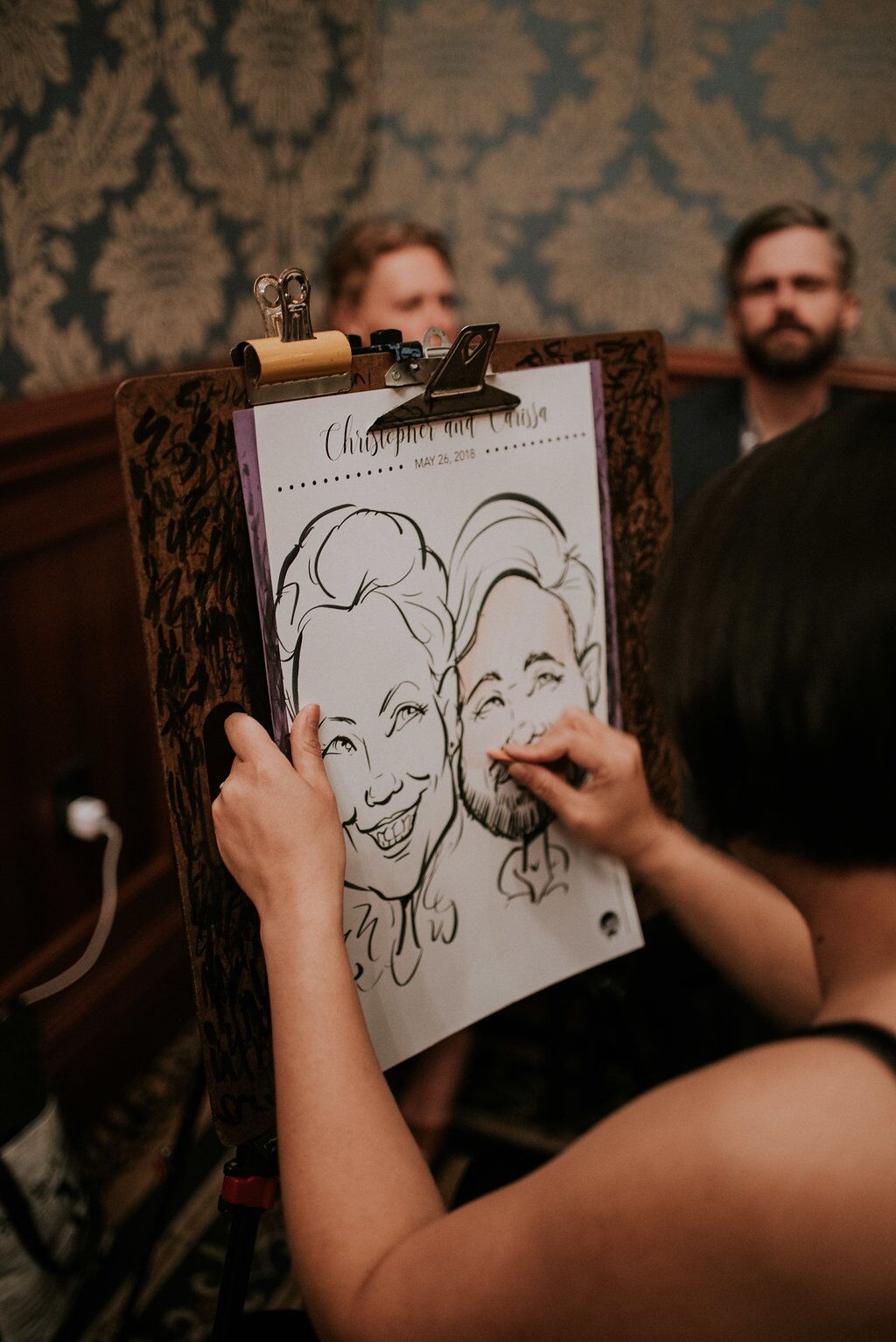 Caricaturist at Wedding Reception drawing guests