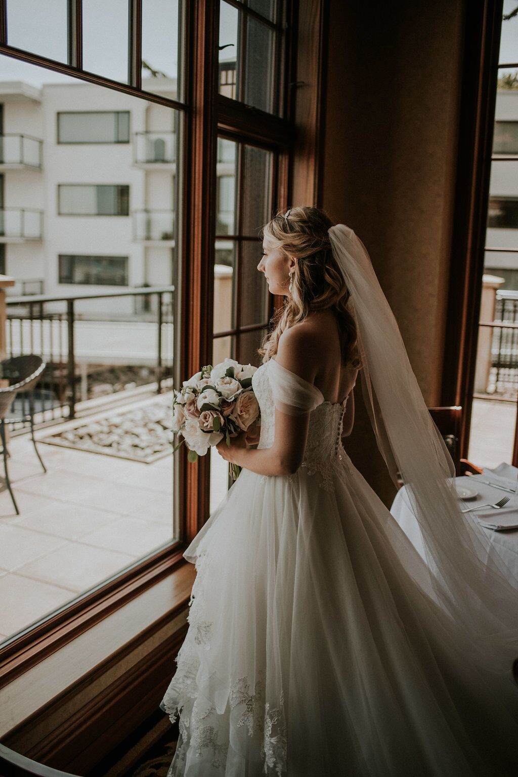 Romantic Bride at Oak Bay Beach Hotel looks out towards the ocean