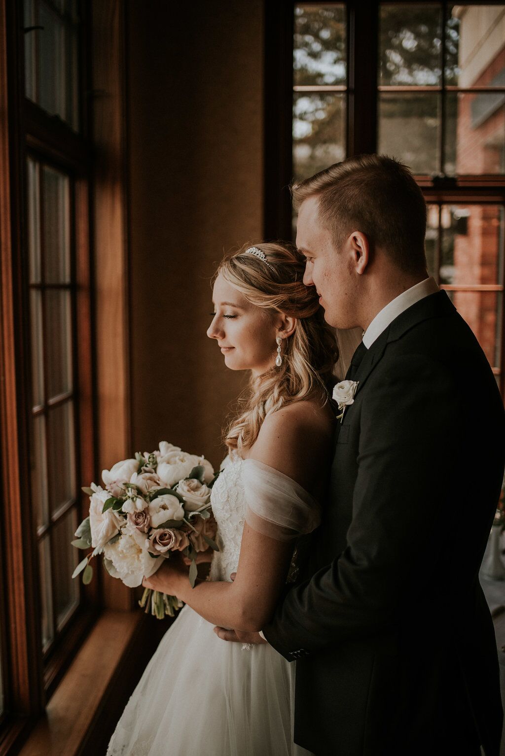 Romantic Newlyweds look out window of Oak Bay Beach Hotel