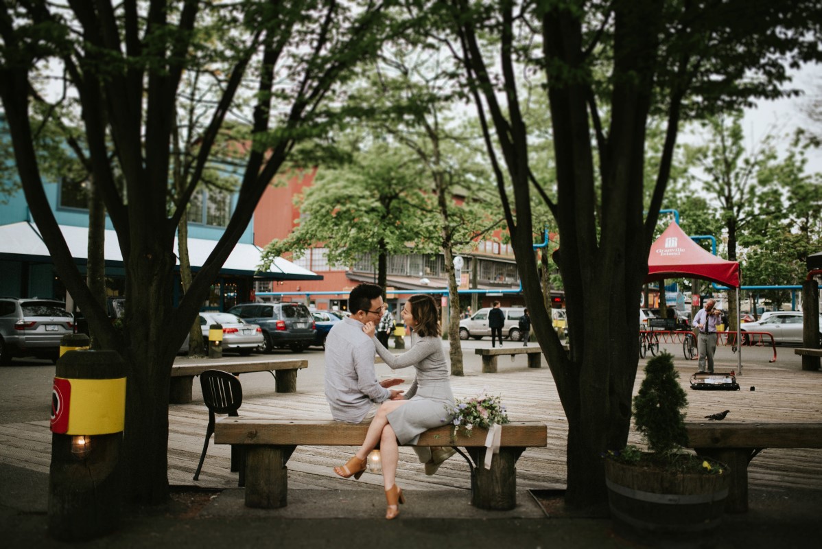 Vancouver Engagement Hari and Kayden sit together on park bench