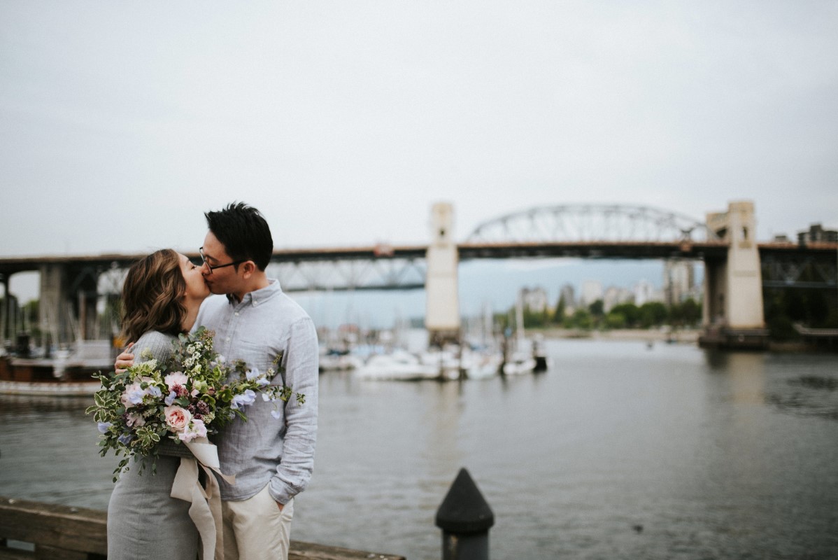 Vancouver Engagement Shot of couple kissing along Vancouver waterfront