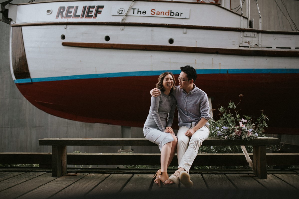 Engaged Couple in front of Wall Paintings in Vancouver Wedding Magazine