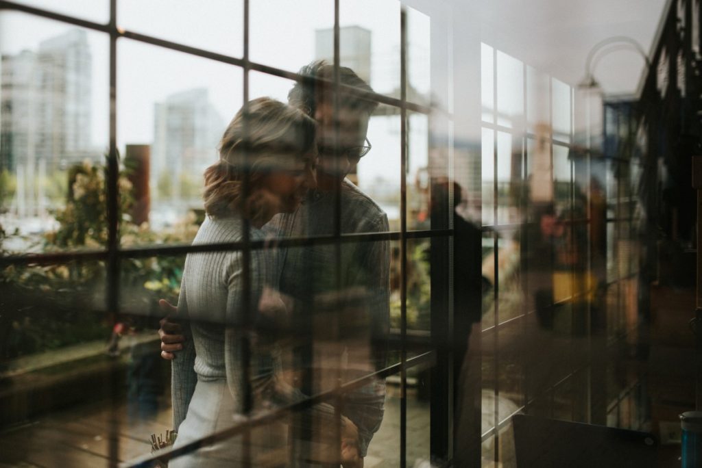 Engaged Couple Reflection through panes of glass