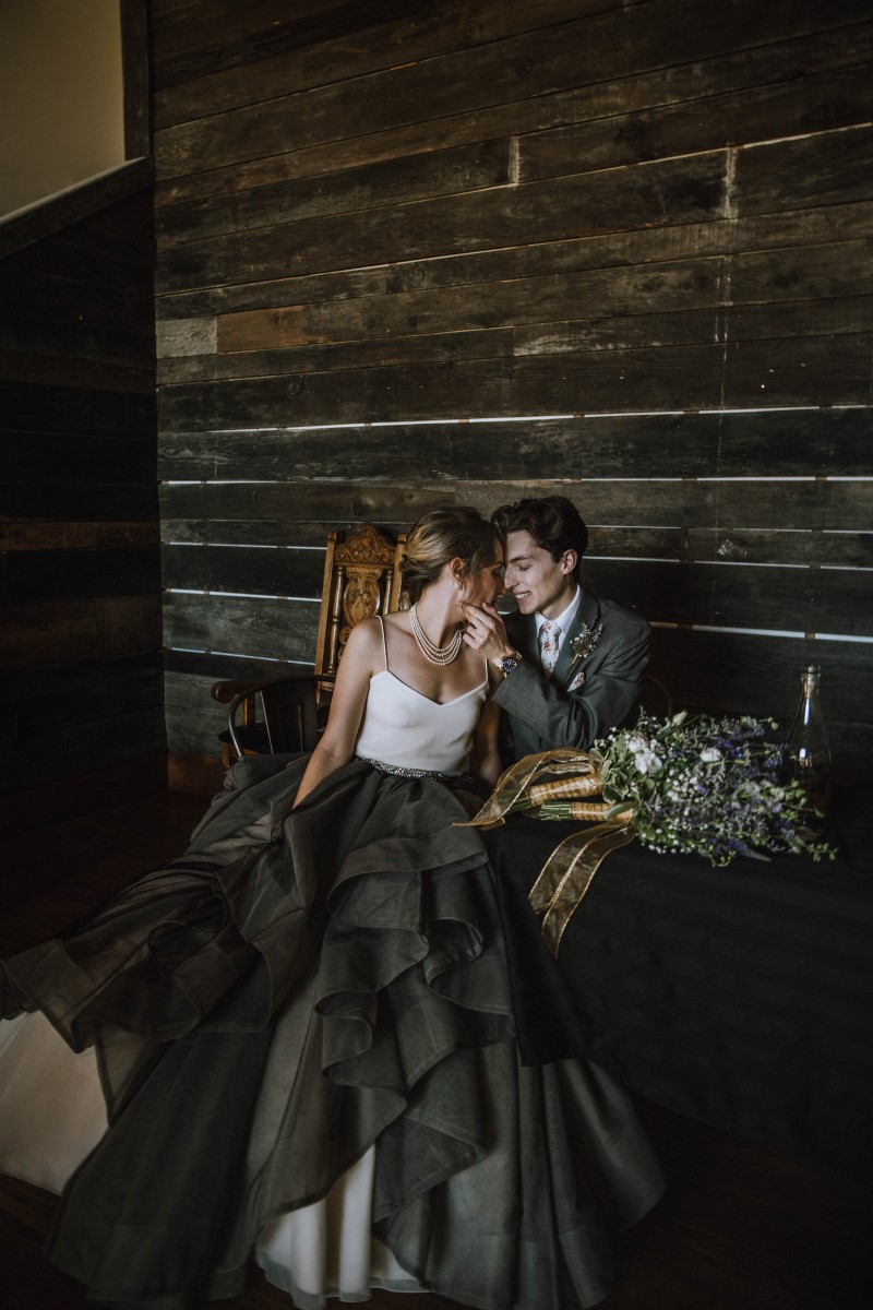 Newlyweds in front of wood wall Vancouver Island Wedding Magazine