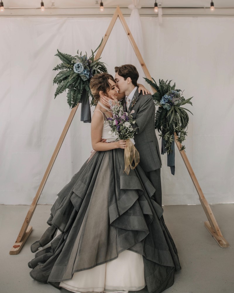 Bride wearing grey blue skirt with white top