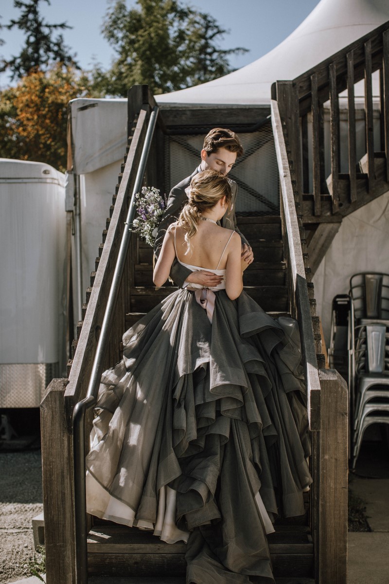 Newlyweds on staircase with bride in grey gown