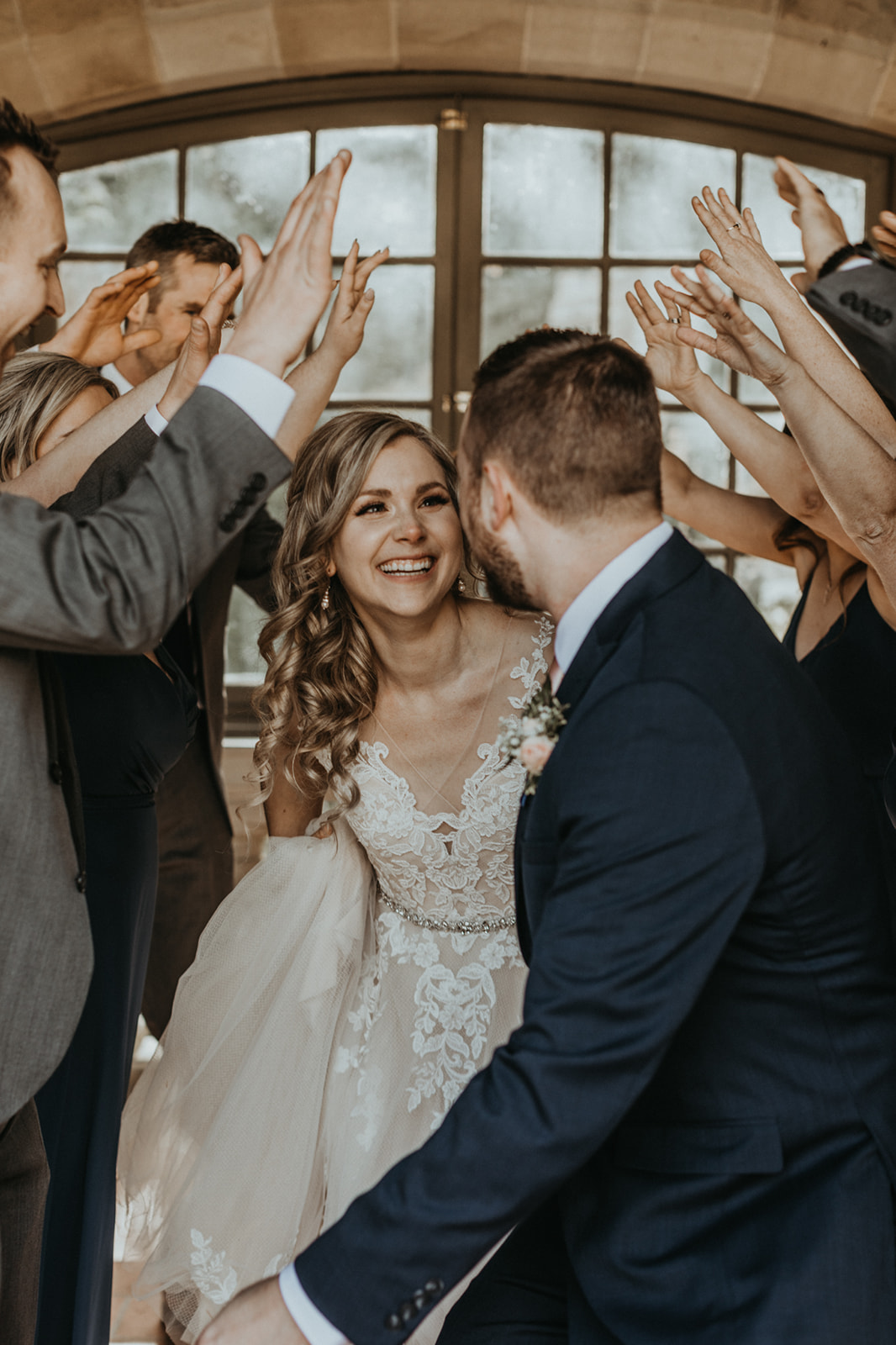 Bride with Makeup by Alexa smiles at groom as friends applaud on Vancouver Island