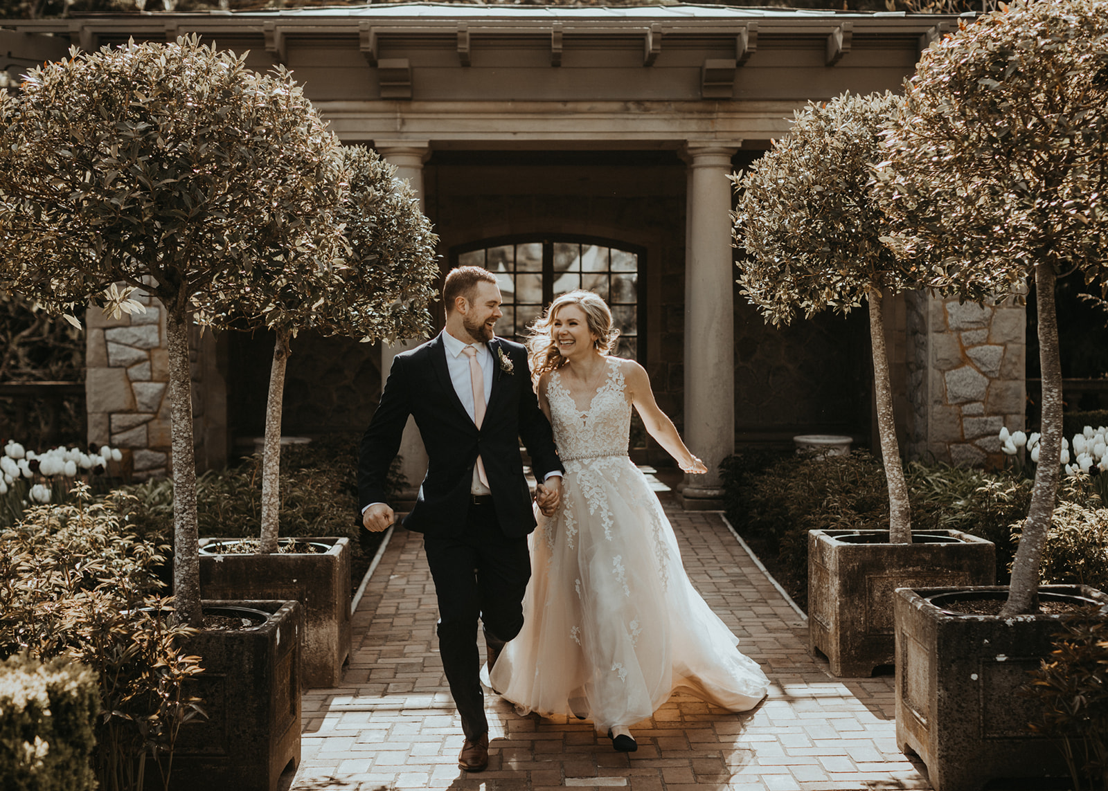 Bride and Groom walk up garden path