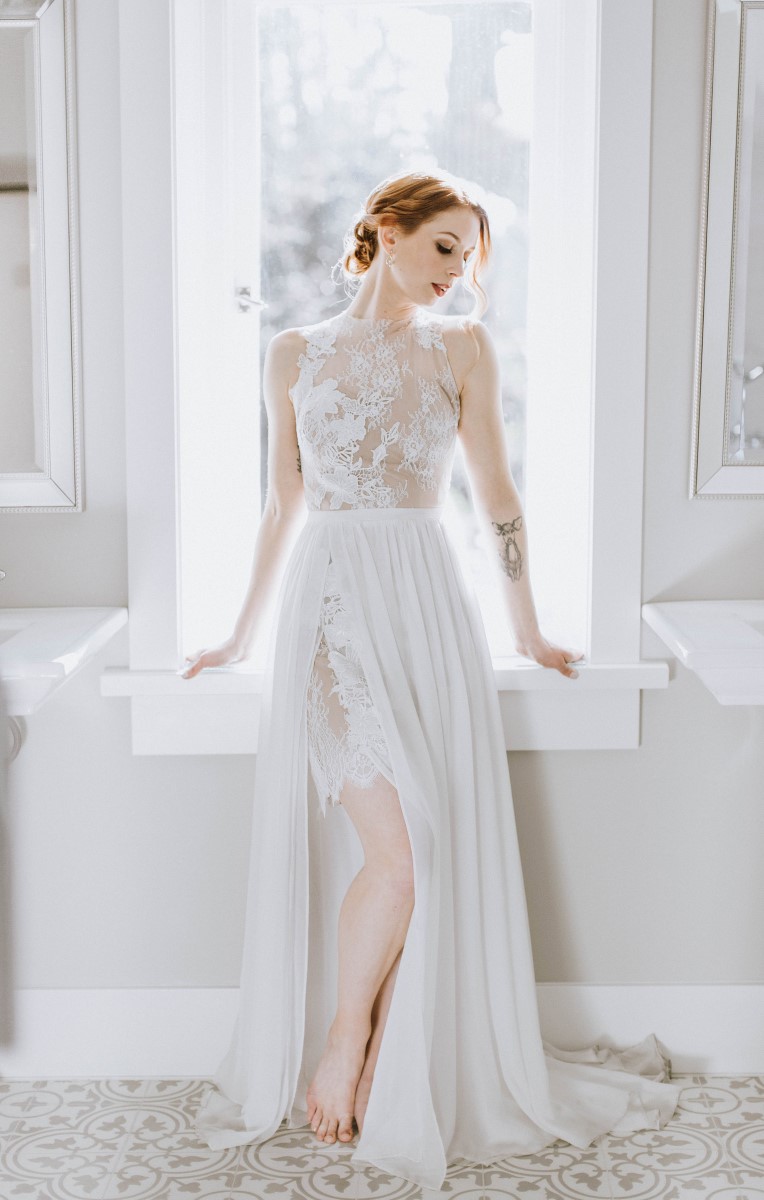 Sophisticated Bride in flowing lace gown sitting on windowsill at Maple Bay Manor