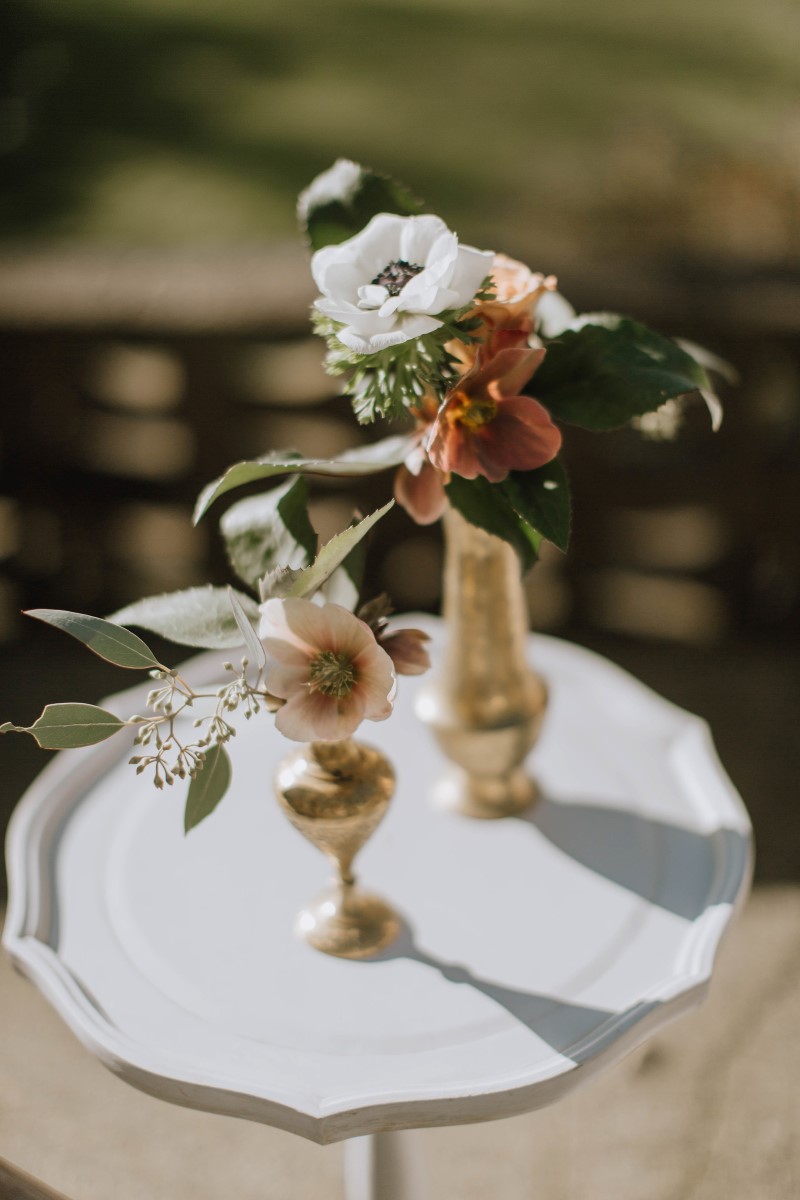 Floral in gold candlesticks by Myrtle and Moss Photography