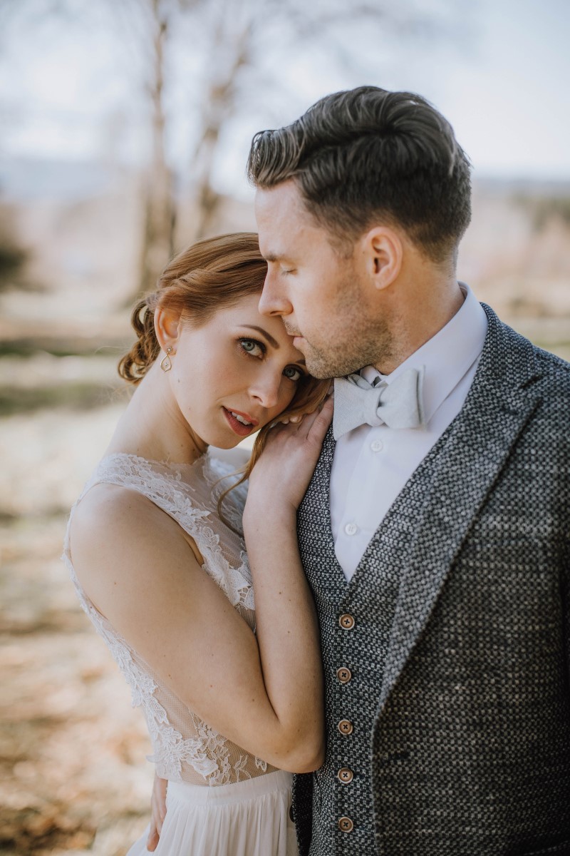 Bride leans on grooms shoulder by Myrtle and Moss Photography