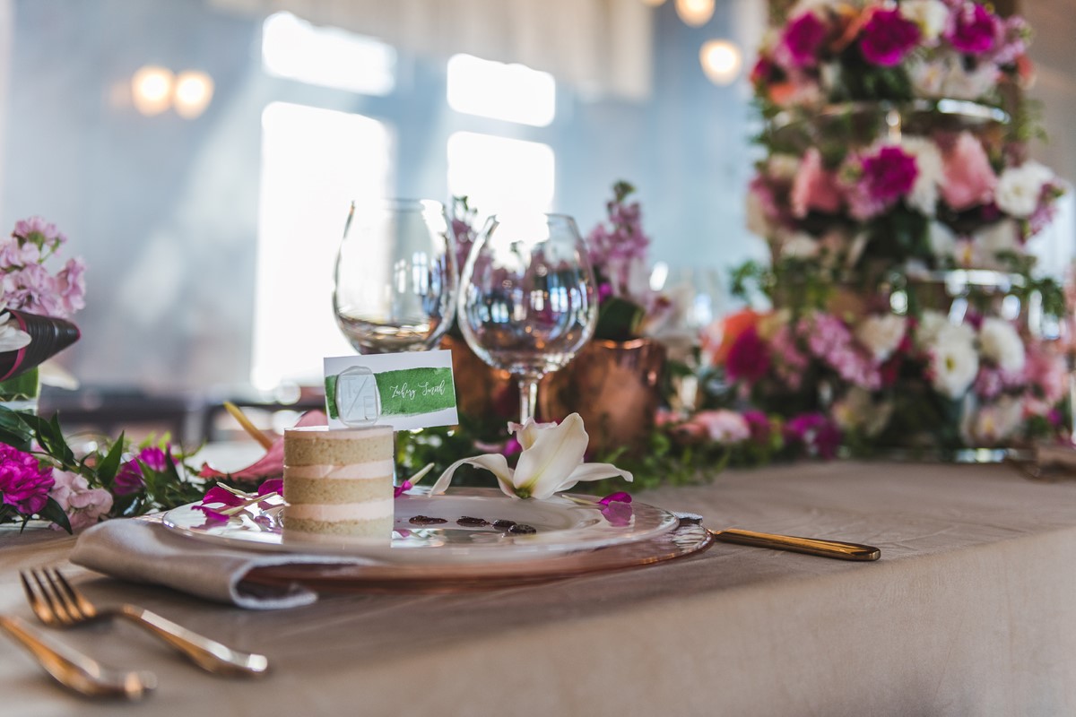 Mini cake sits on pink floral table scape Brown's the Florist at Fairmont Empress