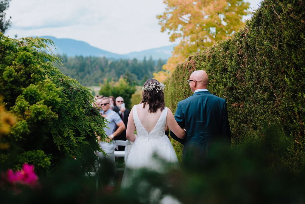 Bride and father walk to ceremony at Arbutus Ridge Golf Club by Megan Maundrell Photography