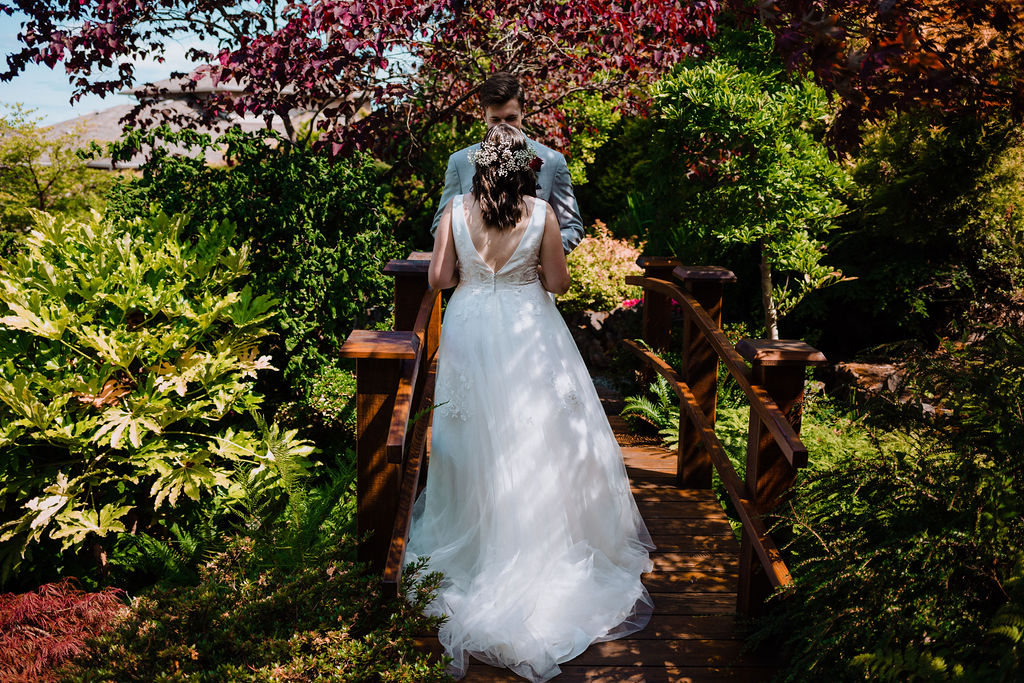 Sun dappled newlyweds walk through Arbutus Ridge Golf Course gardens on Vancouver Island