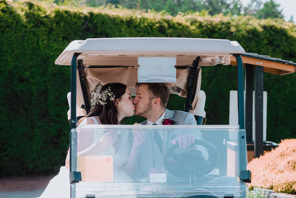 Newlyweds ride the golf cart at Arbutus Ridge on Vancouver Island