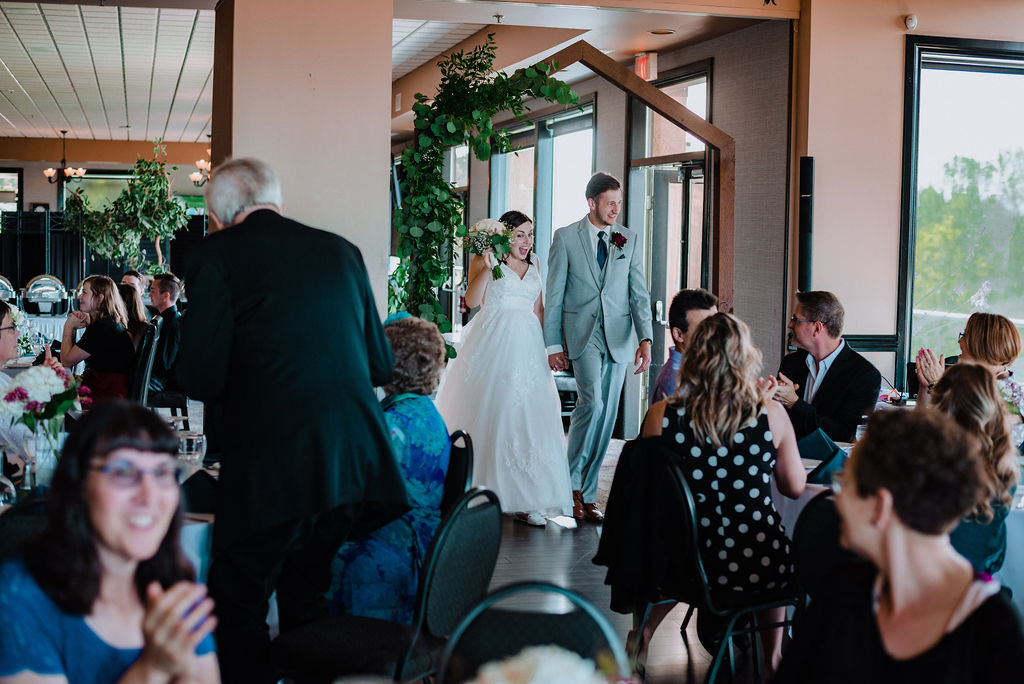 Newlyweds enter reception at Arbutus Ridge Golf Course