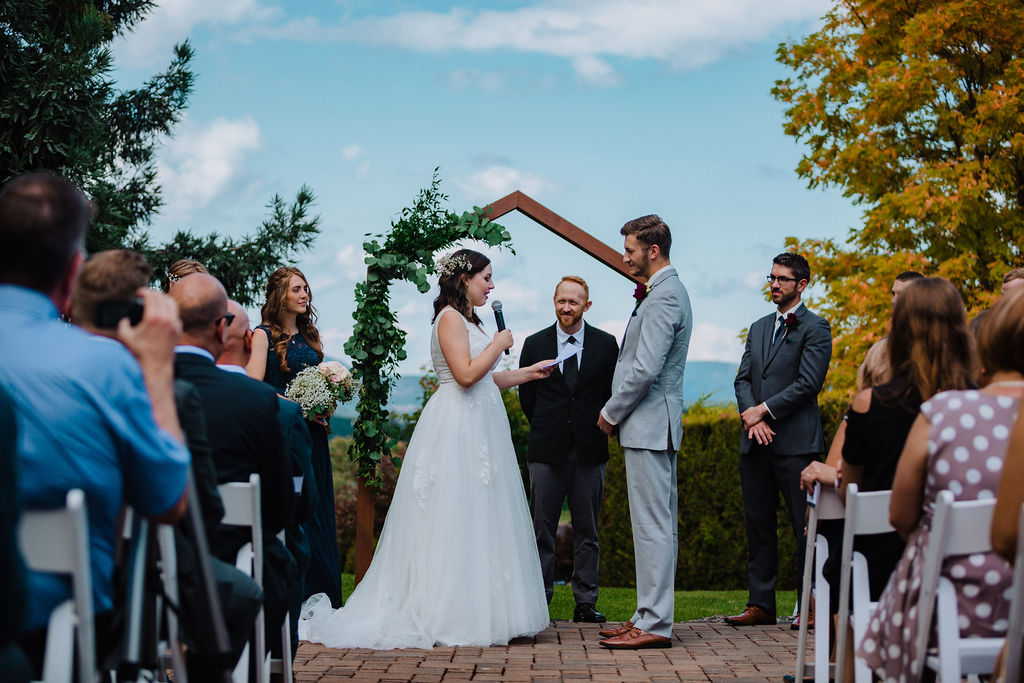 Newlywed Couple exchange rings at ceremony overlooking ocean on Vancouver Island