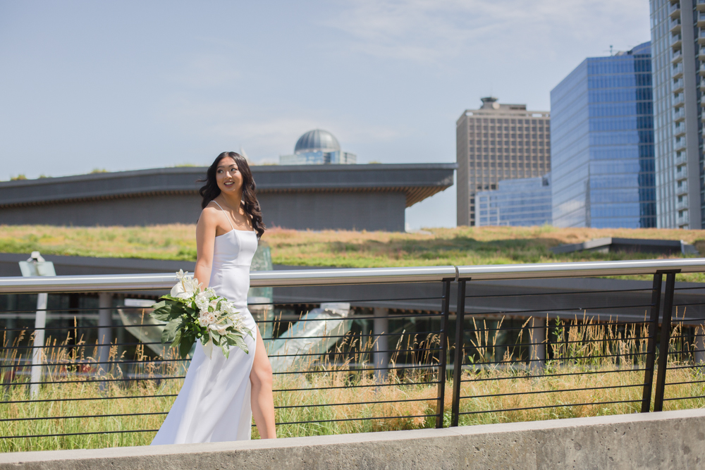 City Chic Bride walks in front of Vancouver Sky