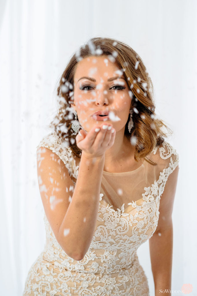 Winter Magic Wedding bride blowing sparkles West Coast Weddings Magazine