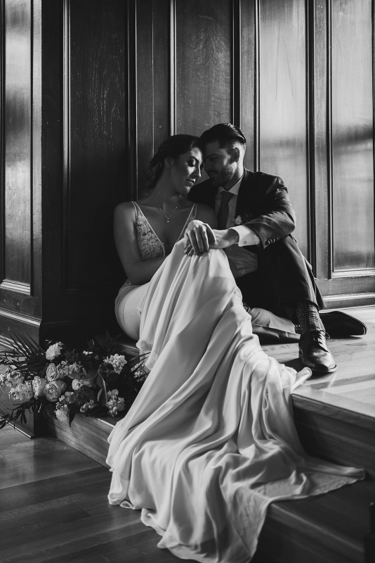 Newlyweds in window seat at Fairmont Empress for West Coast Weddings Magazine