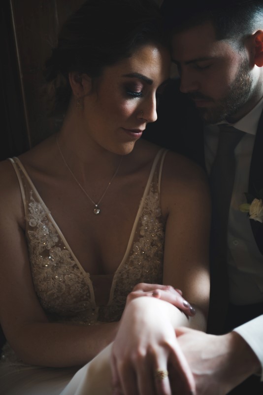 Bridal couple in shadow looking at ring by KGoodPhoto 