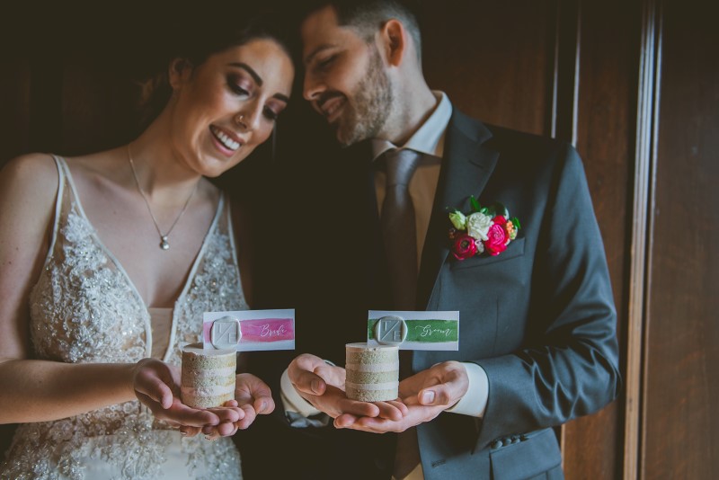 Newlyweds holding individual wedding cakes by Allison Shelrud on Vancouver Island