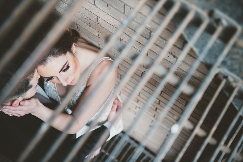 Newlyweds seen through stairwell gate by KGoodPhoto at Fairmont Empress Vancouver Island