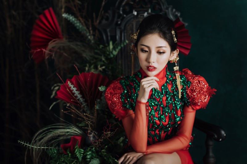 Culture Fusion bride thinking in red and green gown with red fans Silvia Makeup & Hair Vancouver