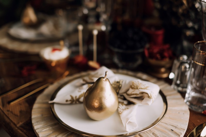 West Coast Weddings Magazine gold pear on white plate with gold rim