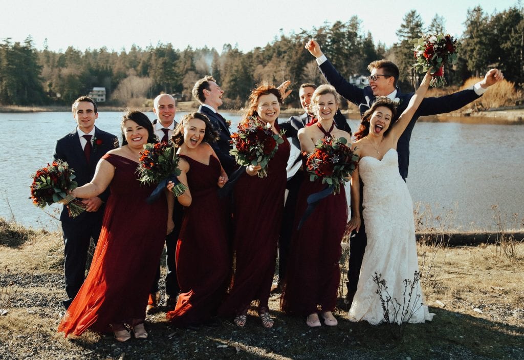 Steal of a Wedding bridal party celebrating on beach